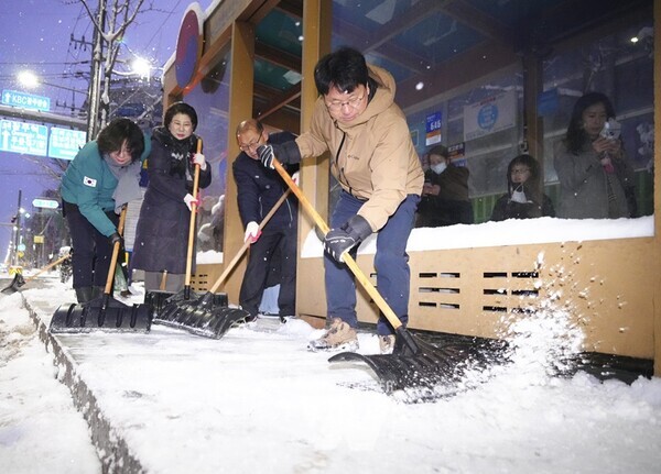 강기정 광주광역시장이 24일 오전 서구 동천동 일원에서 주민들과 함께 도로에 쌓인 눈을 치우고 있다./광주광역시 제공