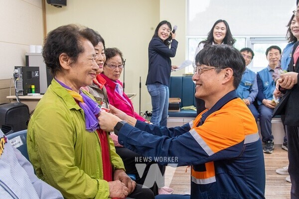 김태영 광양제철소 행정섭외그룹장이 어르신들께 카네이션을 달아드리고 있다.