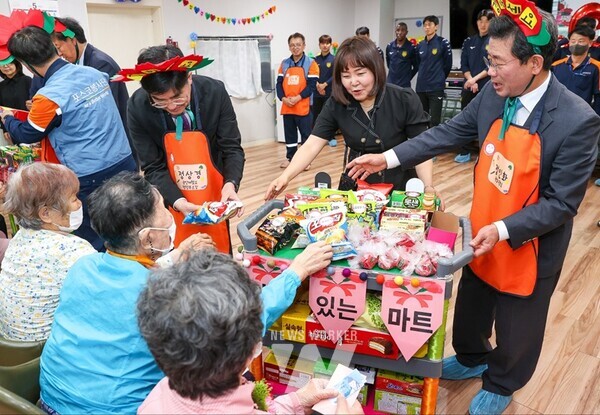 정상경 광양제철소 행정부소장(좌)와 정인화 광양시장(우)가 치매 어르신들을 위한 마트 장보기 프로그램에 참여하고 있다.