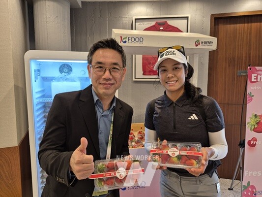 태국 골프선수에게 딸기를 선물하는 aT방콕 지사장(작년 대회 우승자-패티 타바타나낏)