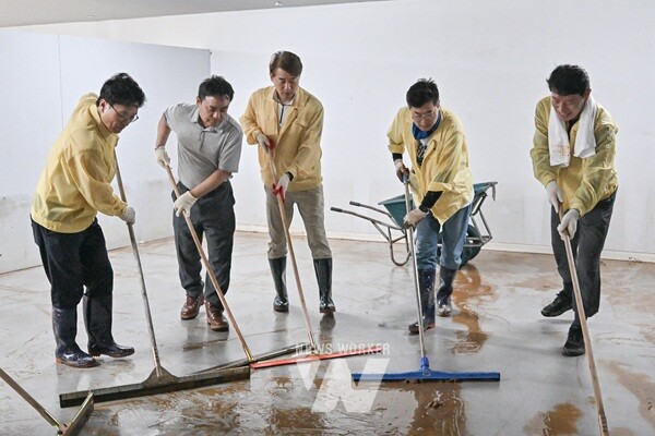 김이강 광주 서구청장이 21일 집중호우 침수 피해를 입은 서구 관내의 한 가구점에서 박찬대 더불어민주당 당대표 후보, 자원봉사자들과 복구 작업을 하고 있다. /광주 서구 제공